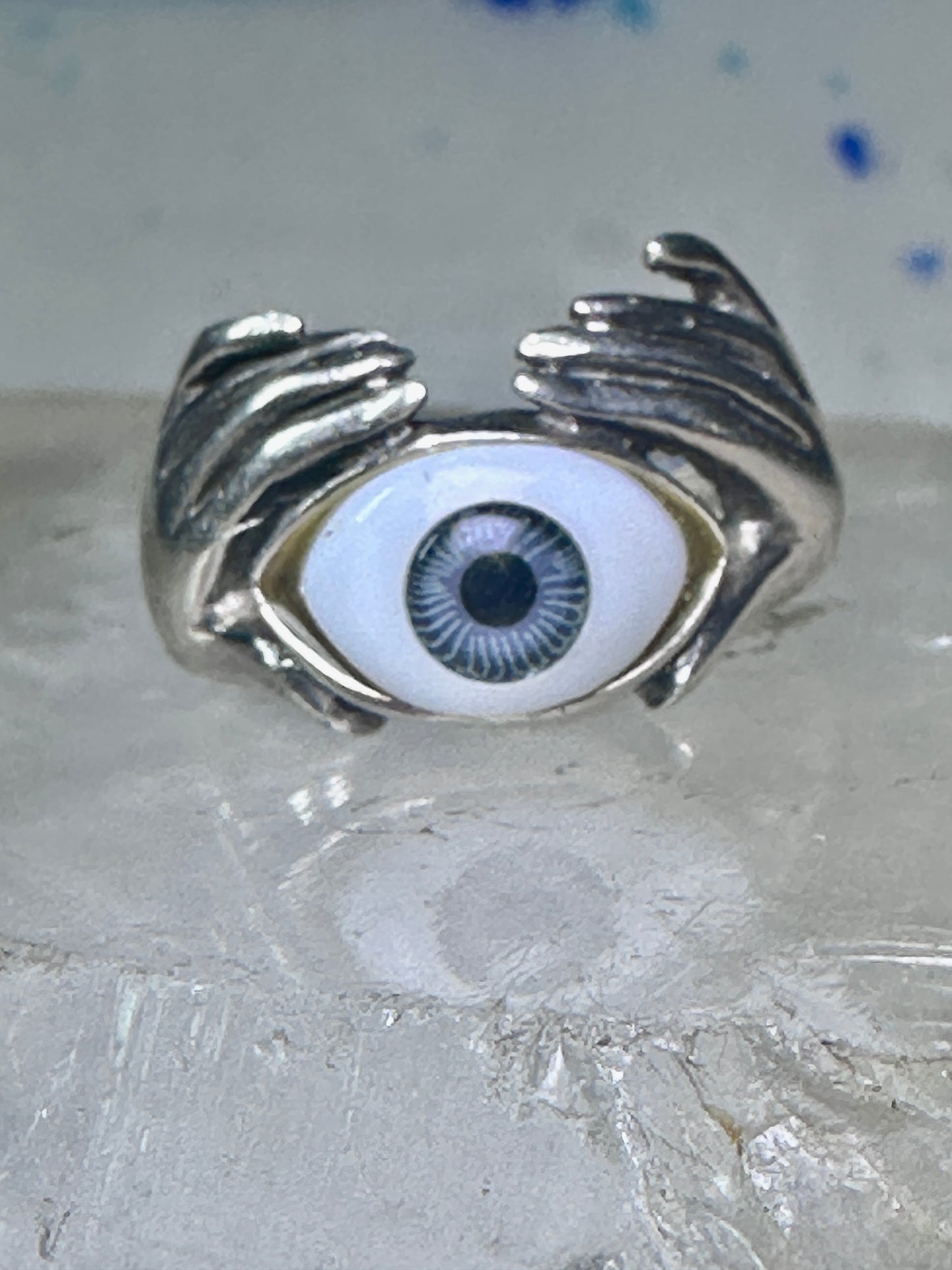 Hands holding an Eye ring pinky band size 5.50 sterling silver women