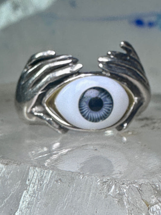 Hands holding an Eye ring pinky band size 5.50 sterling silver women