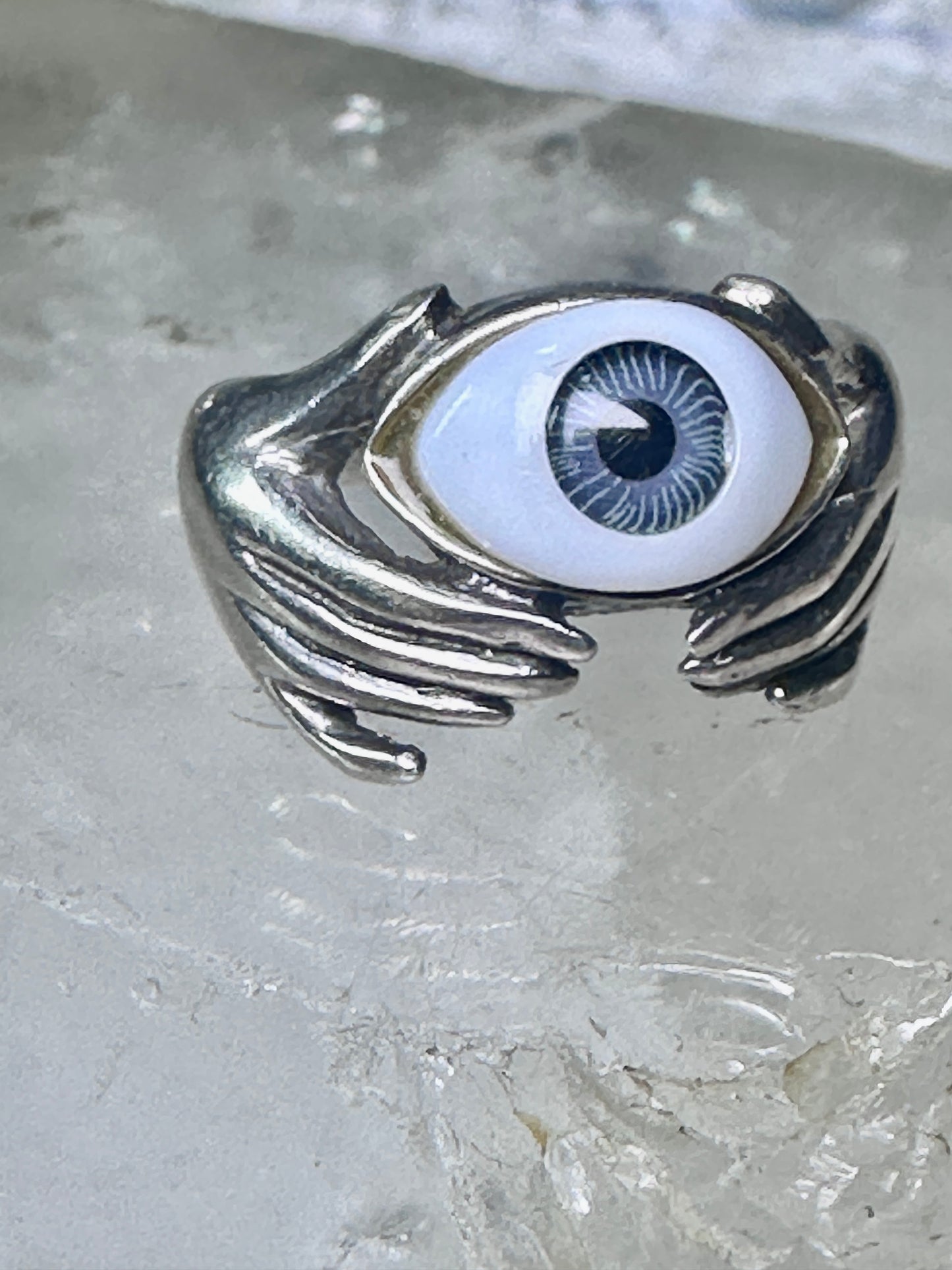 Hands holding an Eye ring pinky band size 5.50 sterling silver women