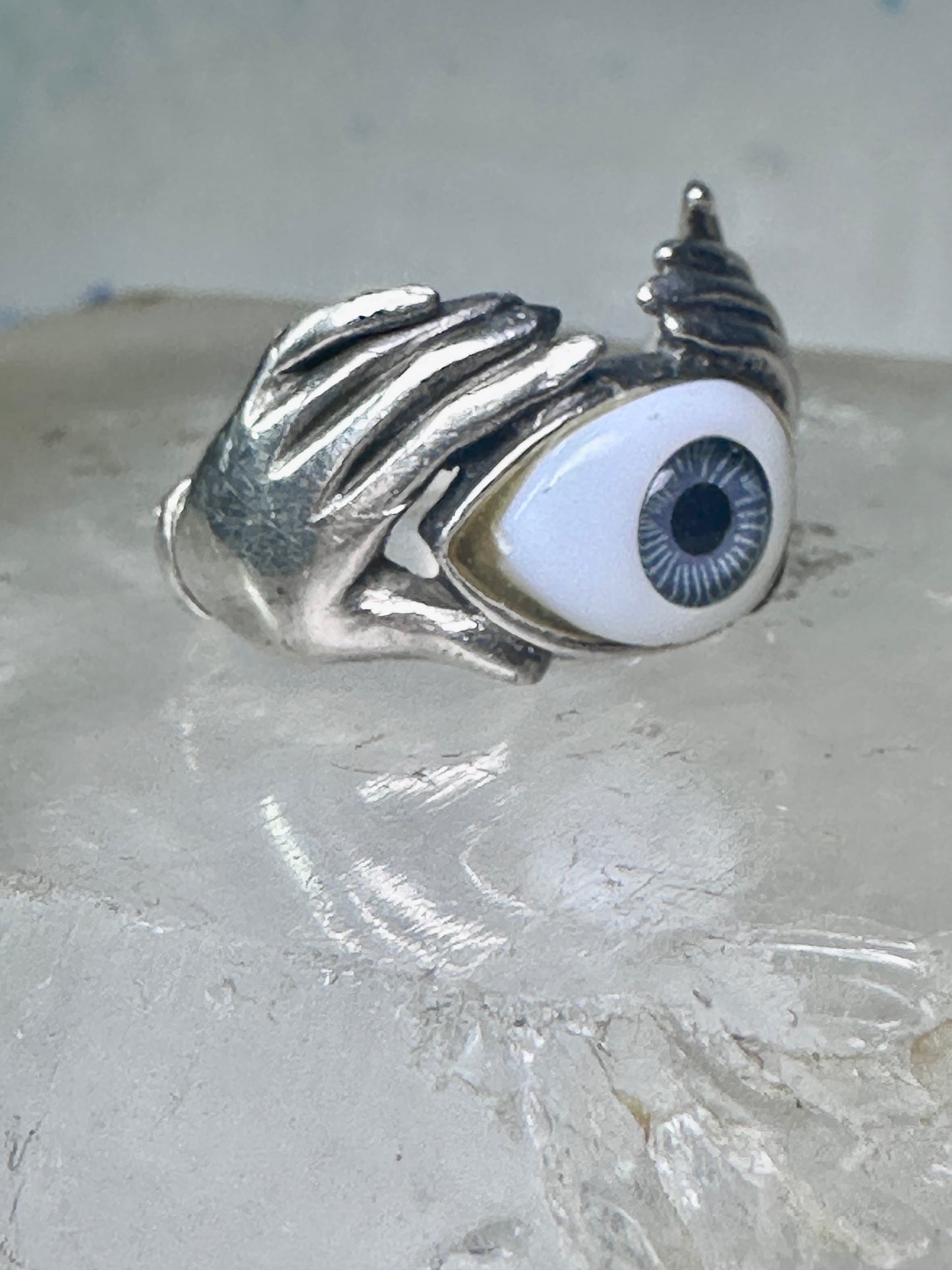 Hands holding an Eye ring pinky band size 5.50 sterling silver women
