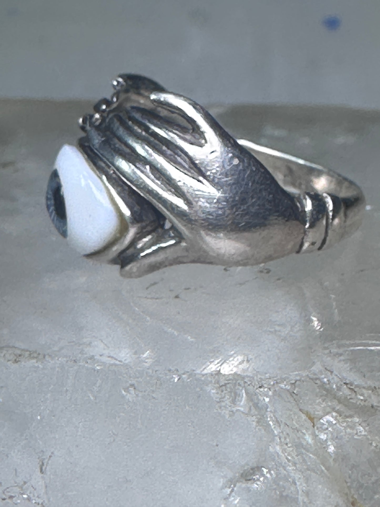 Hands holding an Eye ring pinky band size 5.50 sterling silver women