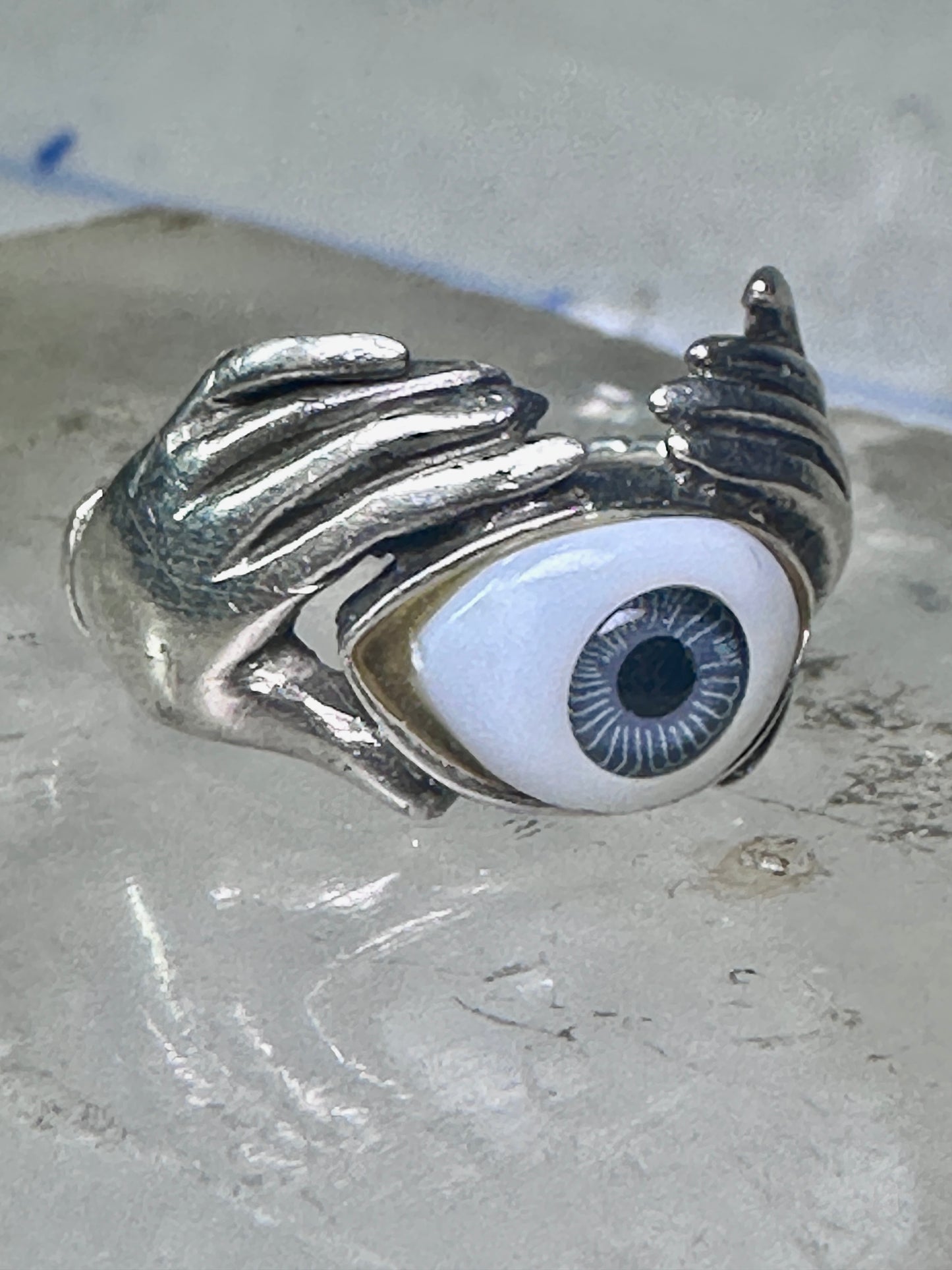 Hands holding an Eye ring pinky band size 5.50 sterling silver women