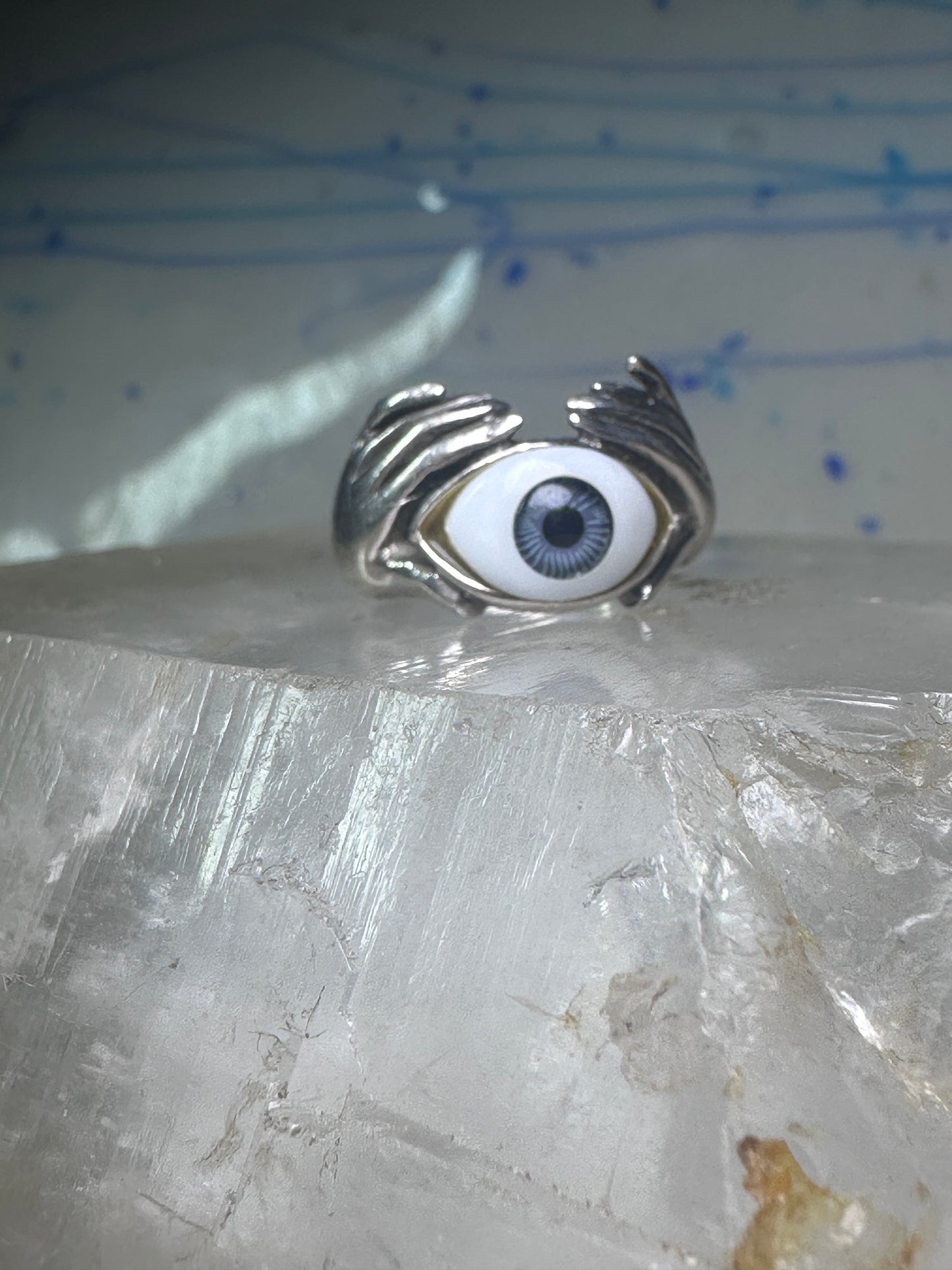 Hands holding an Eye ring pinky band size 5.50 sterling silver women