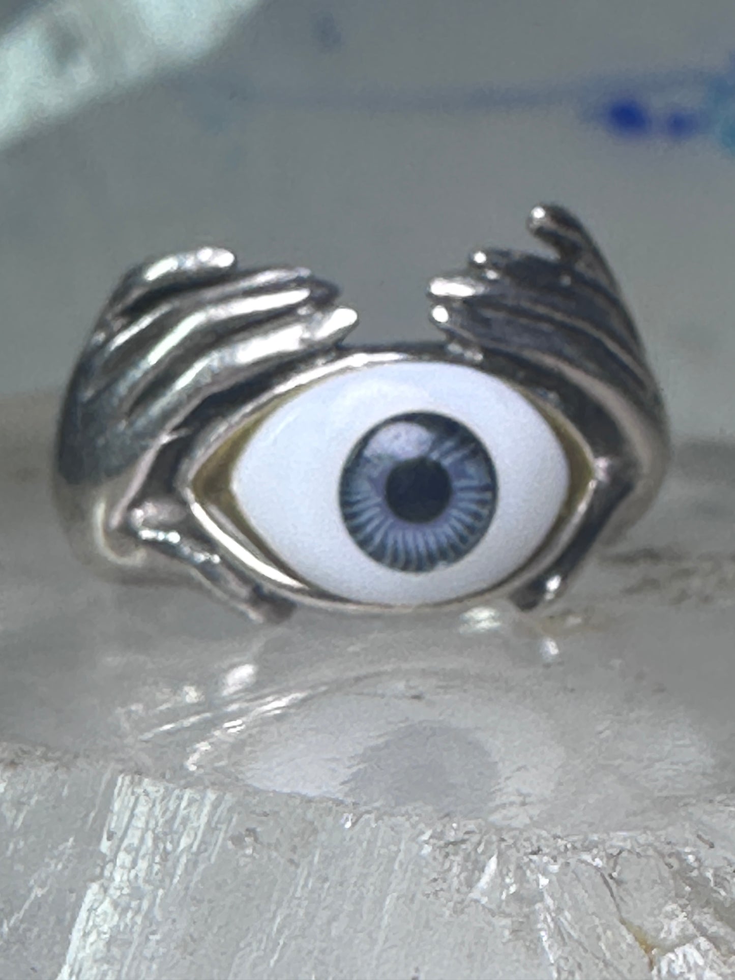 Hands holding an Eye ring pinky band size 5.50 sterling silver women